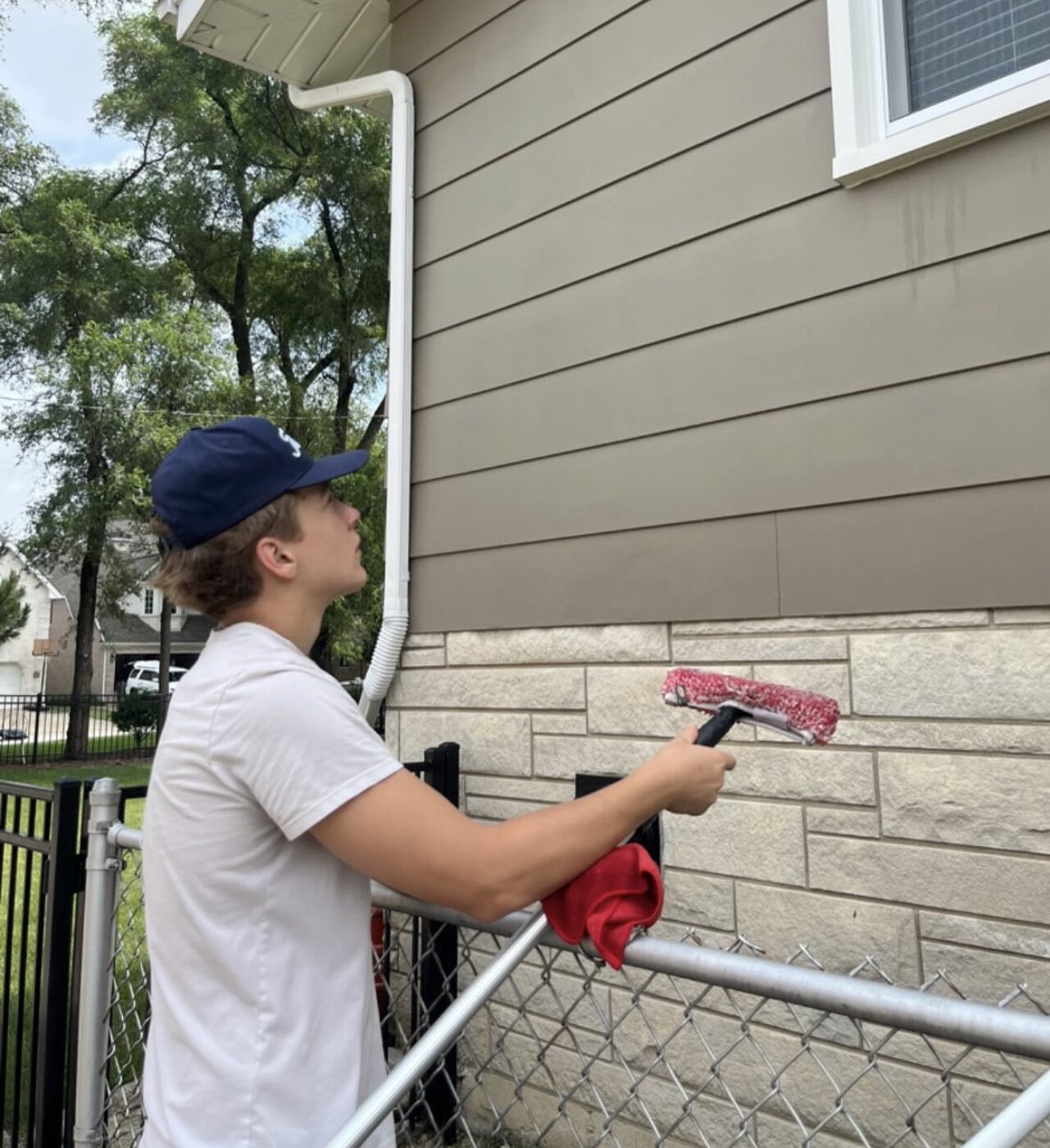 Squeegee window cleaning on a suburban home