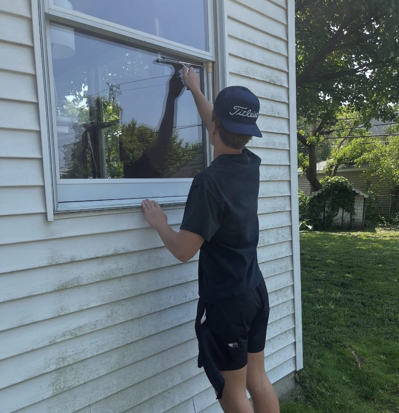 Cleaning ground-floor windows on a home