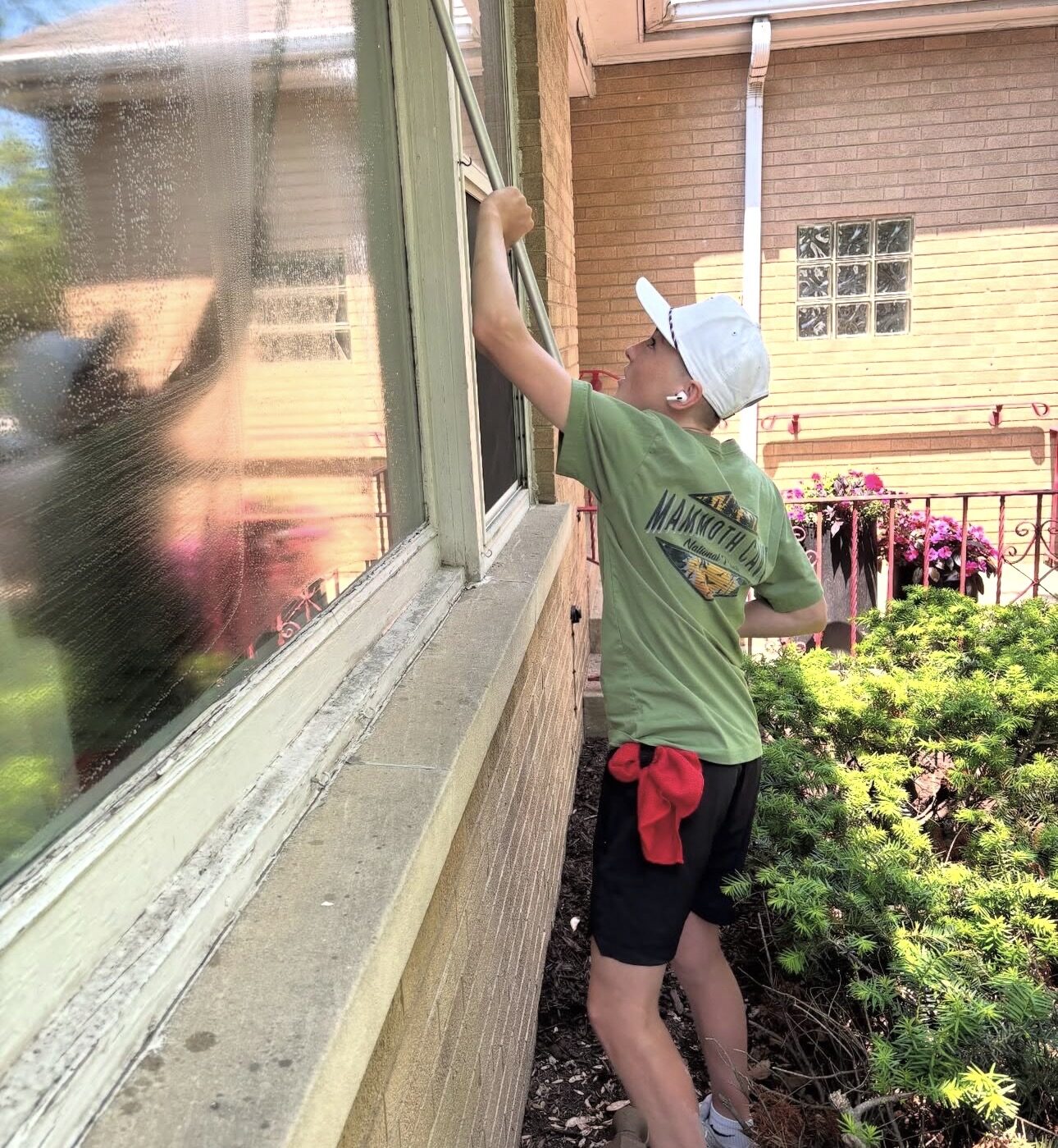 Ultra View cleaning a large home window with a water-fed pole