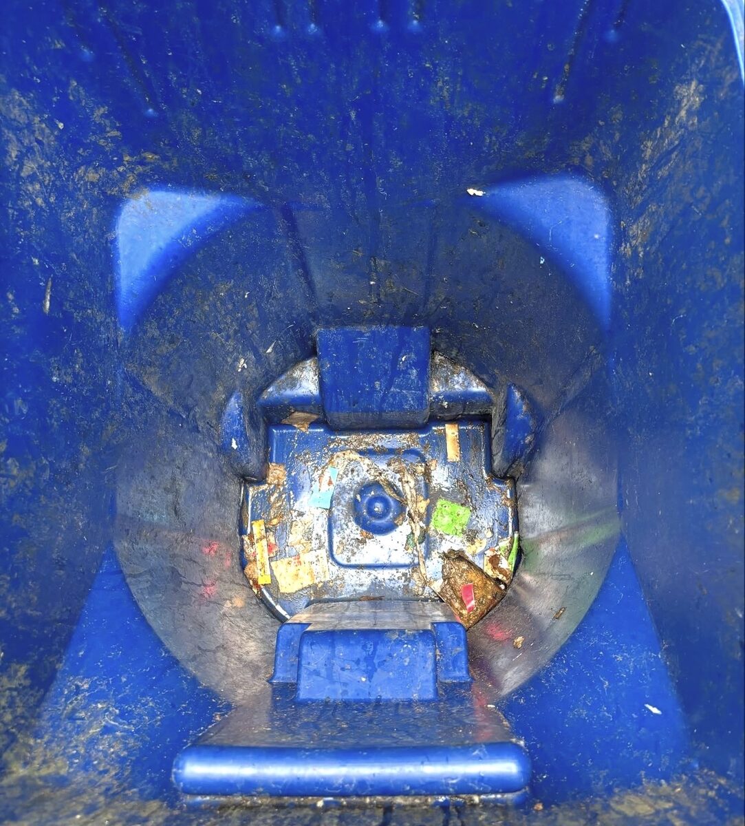 Inside of a dirty garbage bin before cleaning