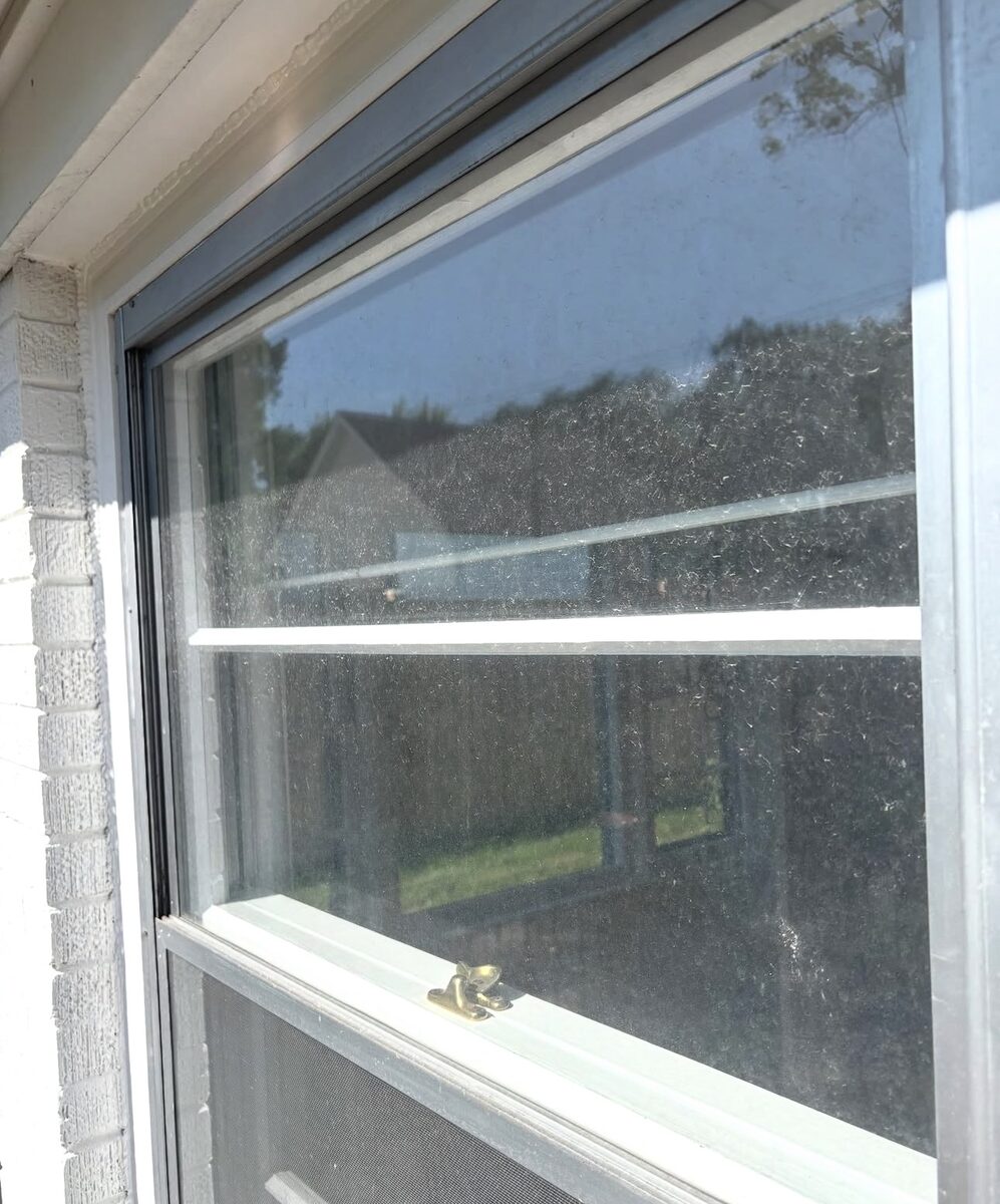 Double-hung window before cleaning